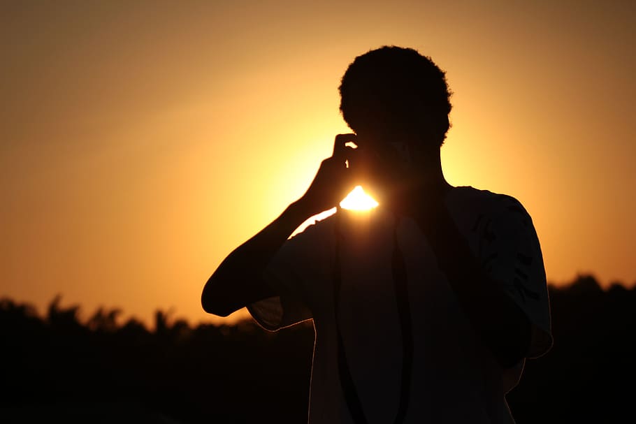 sunset, silhouette, person, one person, sky, waist up, orange color HD wallpaper