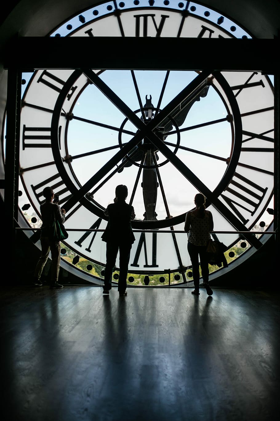 three people standing inside Big Ben building, three people inside gigantic clock