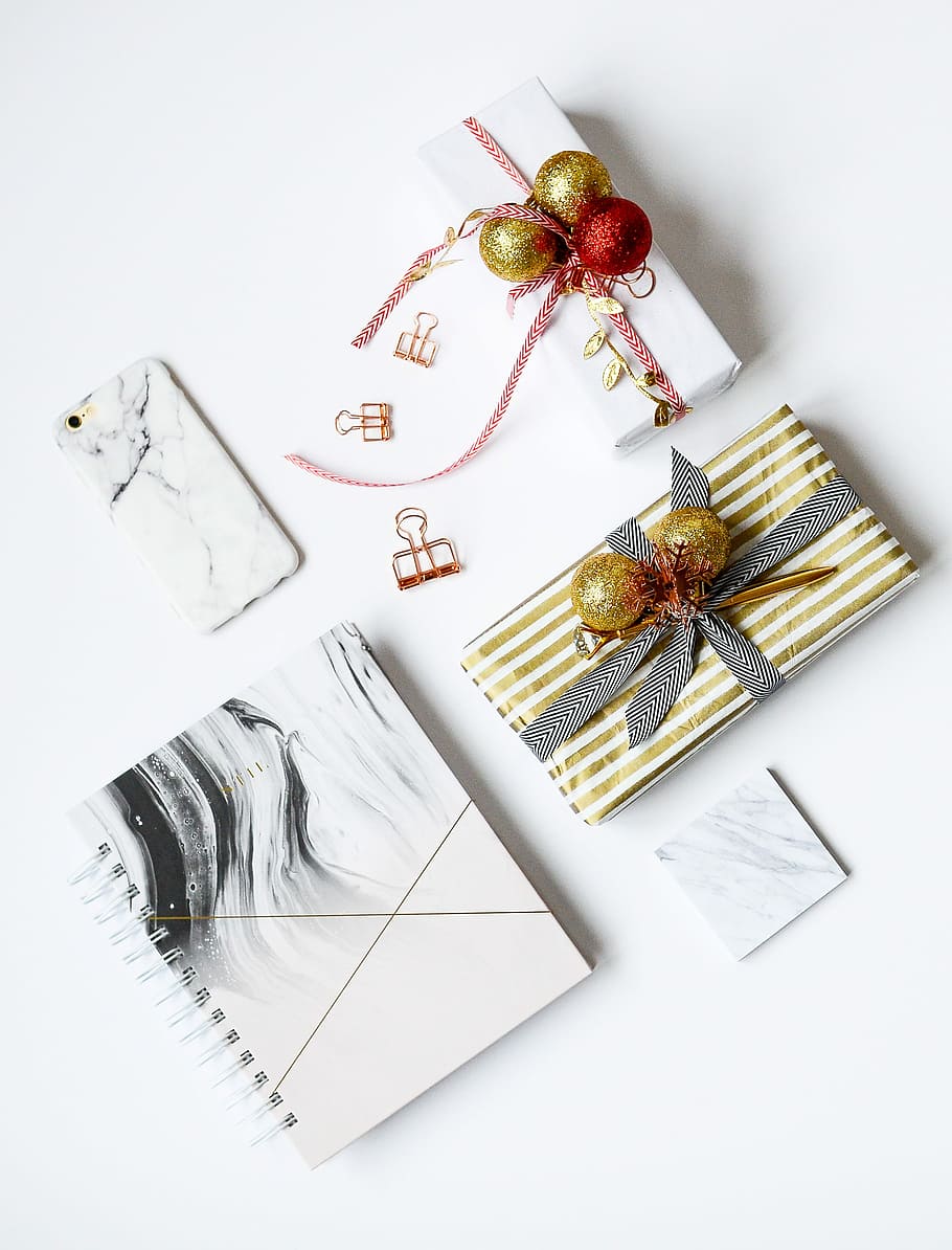 several assorted-color present boxes and notebook on table, white and gold boxes besides white phone HD wallpaper