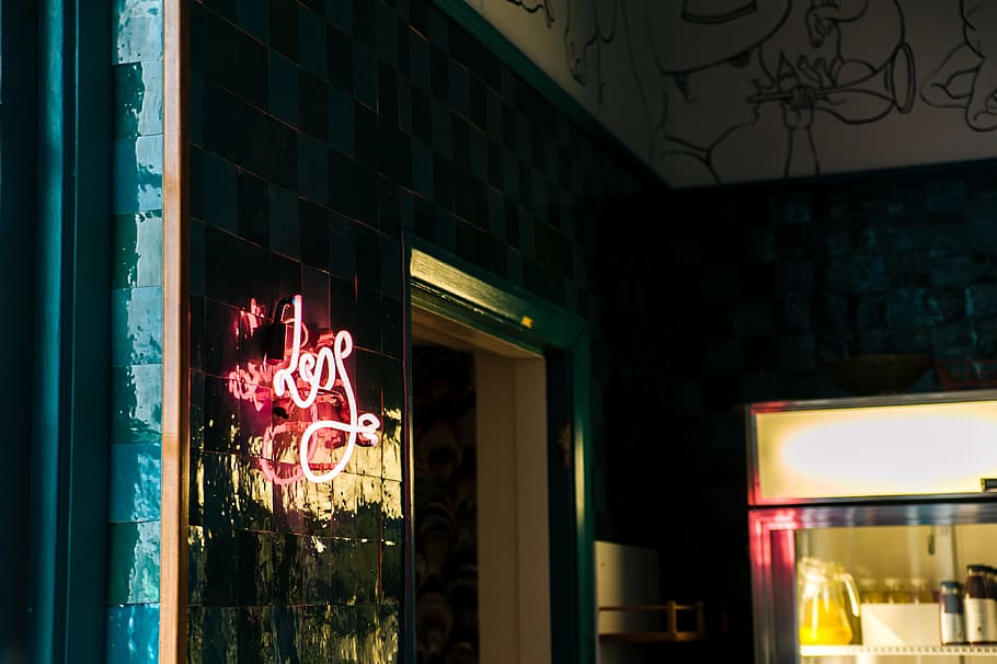 Less Neon Sign Mounted on Glass Board Near Open Window and Glass Display Rack HD wallpaper