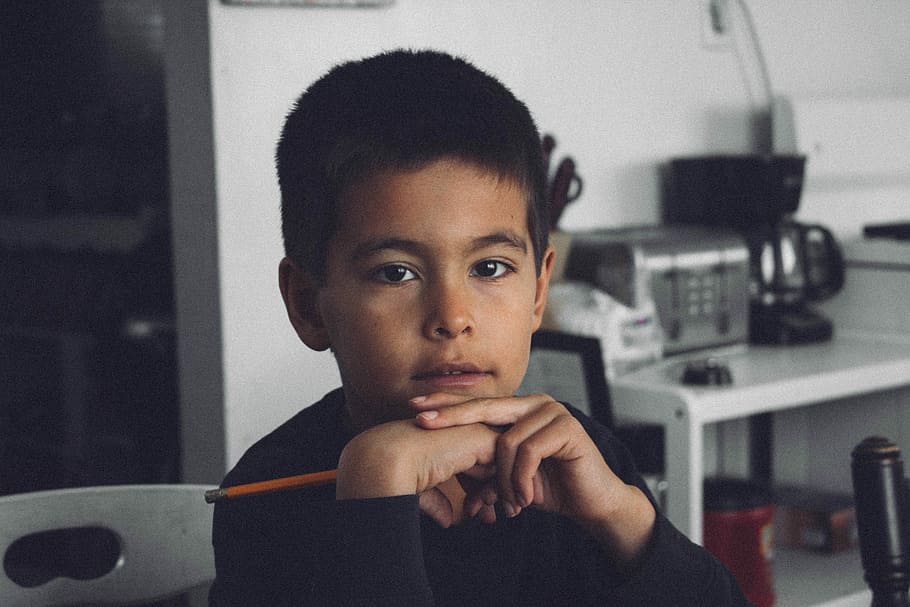 The boy, boy holding pencil sitting near table, portrait, kid, HD wallpaper