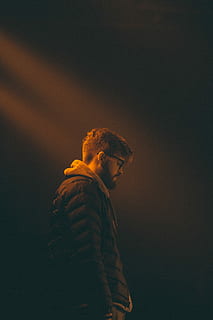 man with brown jacket, beard, portrait, person, looking down HD wallpaper