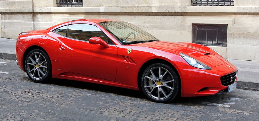 HD wallpaper: red Ferrari coupe parked near beige building, ferrari  california | Wallpaper Flare