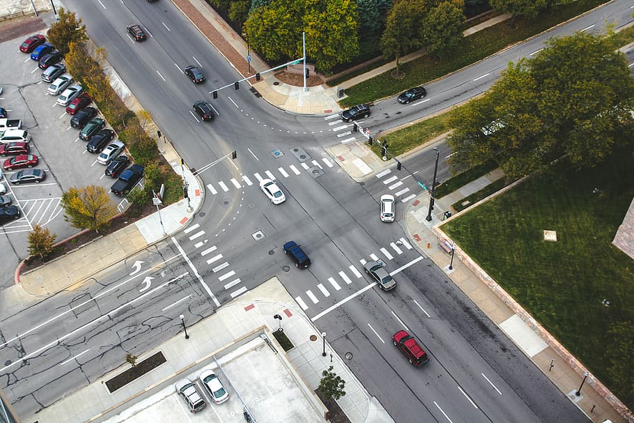 aerial photography of cars on road intersection, aerial photography of vehicles cross at cross intersection at daytime