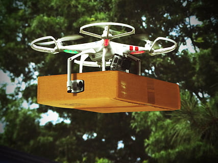 red and white DJi Phantom drone carrying brown cardboard box hovering on mid air HD wallpaper