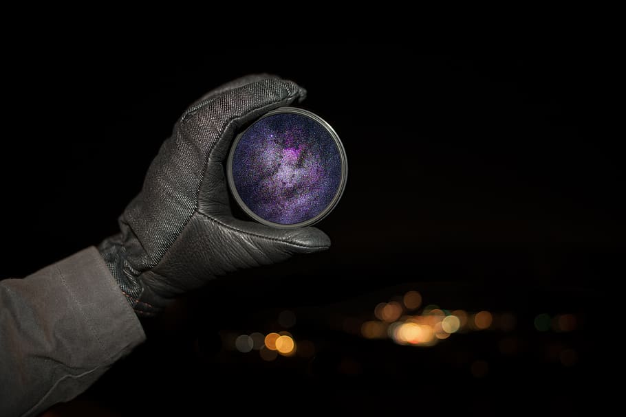 person holding round purple case, person holding round purple ornament HD wallpaper