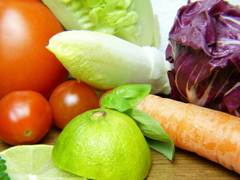 sliced green fruit beside orange carrot, vegetables, lemon, healthy