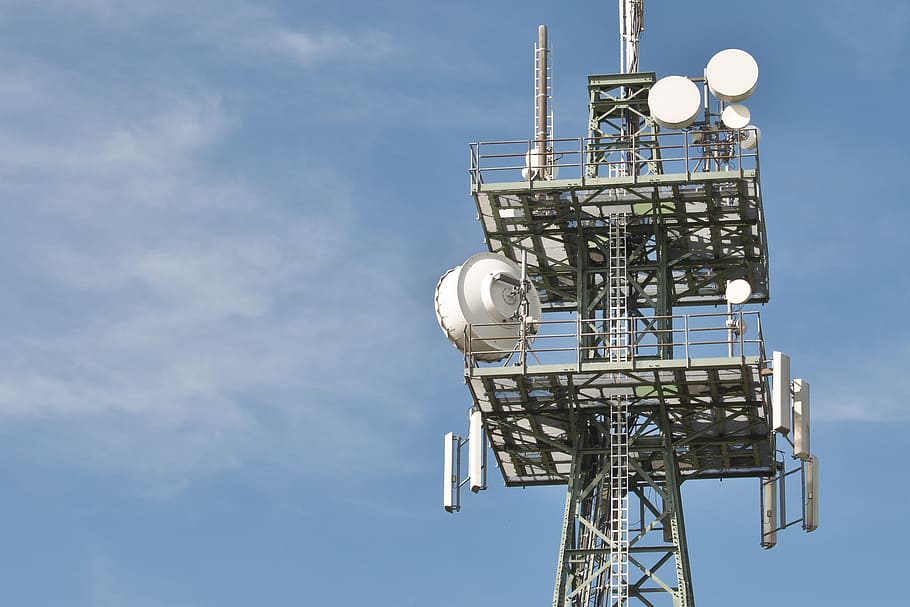 network signal antenna under cloudy sky, radio masts, phone, telephone poles
