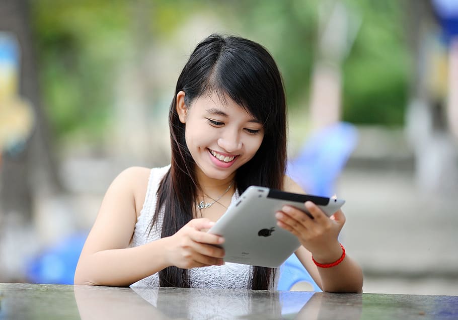 woman holding iPad in front table, girl, tablet, internet, technology HD wallpaper