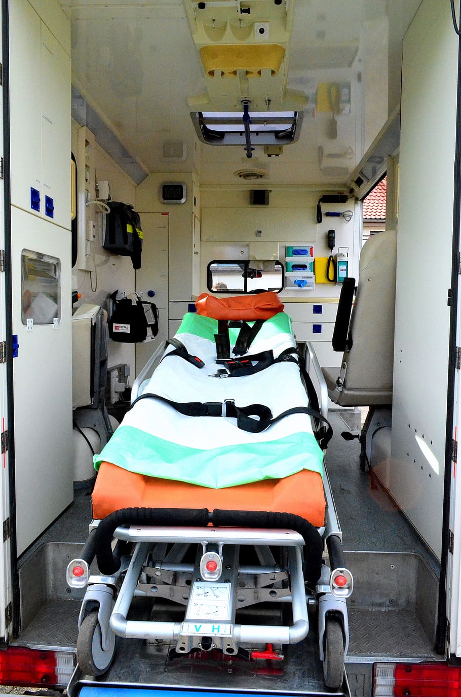 orange ambulance bed in vehicle, ambulance service, first aid