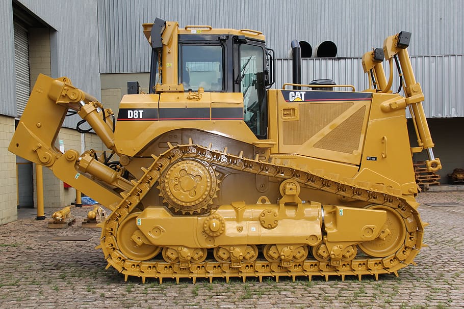 brown and black CAT heavy equipment outside the building, caterpillar, HD wallpaper