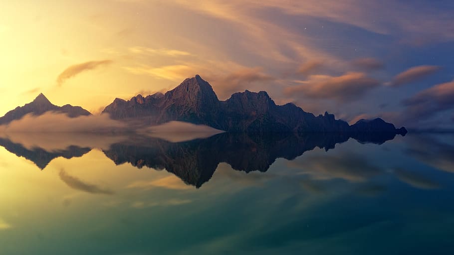 brown mountain mirrored in body of water, photography of mountain with fogs HD wallpaper