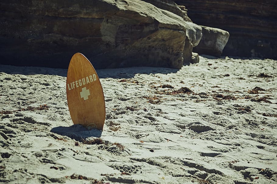 brown Lifeguard skimboard on gray sand, beach, surfboard, wooden, HD wallpaper