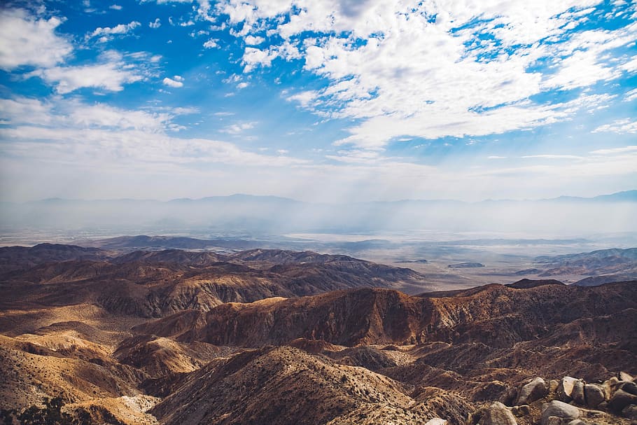 birds eye view of mountain, aerial photography of mountain below white skyt HD wallpaper