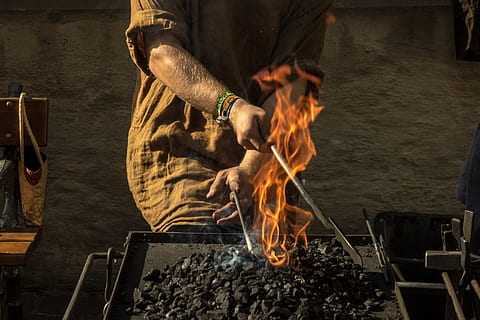 person in brown elbow-sleeved top igniting charcoal photo, forge HD wallpaper