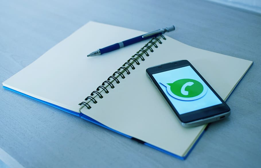 black smartphone on top of notebook, cellular, address book HD wallpaper