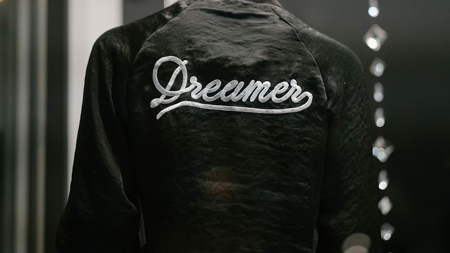 black Dreamer-printed jacket, person wearing black and white Dreamer top HD wallpaper