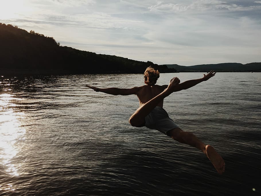 person jump into body of water during daytime, outdoors, women HD wallpaper