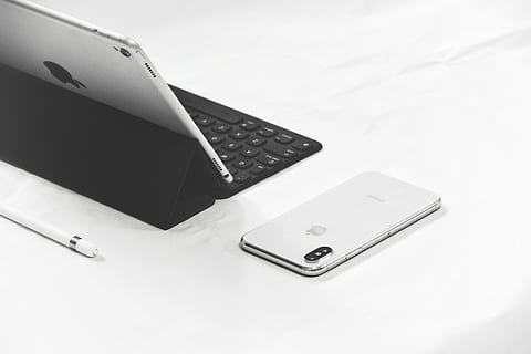 silver iPhone X beside MacBook Pro, silver iPhone X on white surface HD wallpaper