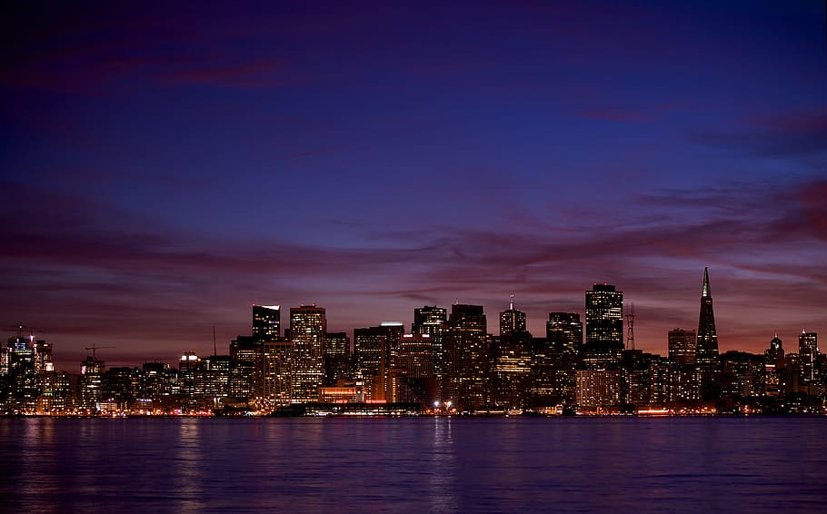 high rise buildings during night time, high rise building near body of water HD wallpaper