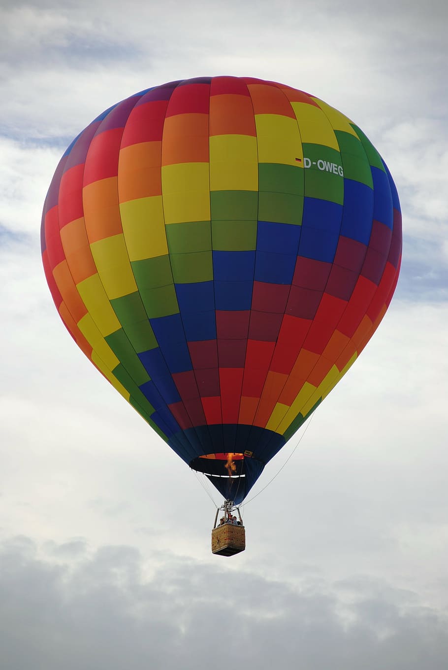 floating multicolored hot-air balloon under gray sky during daytime