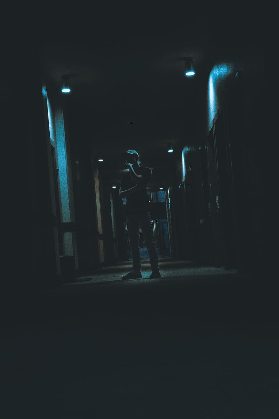 Dark Nights, man standing between lockers, male, lights, illuminated