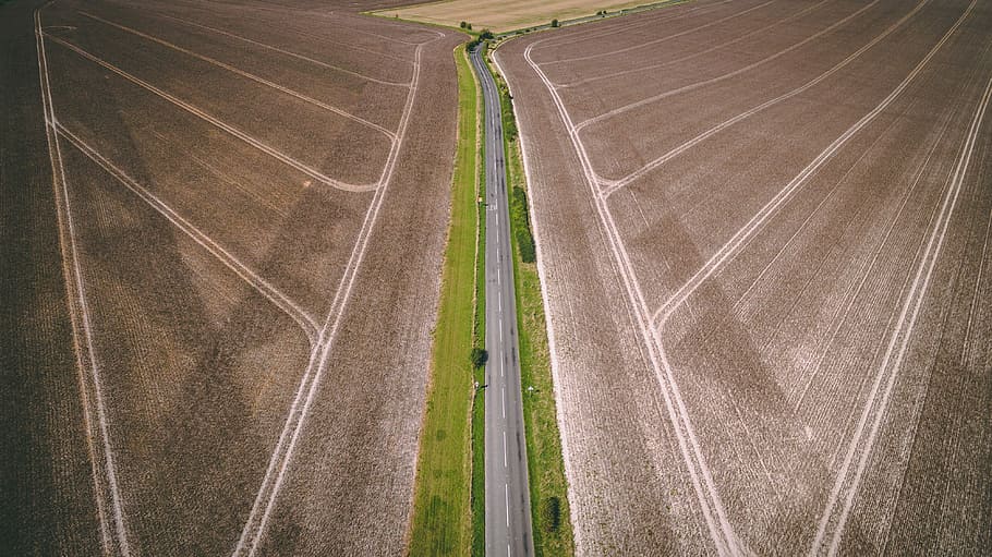 aerial photography of gray concrete road top between brown field during daytime, aerial photography of blacktop road between fields HD wallpaper