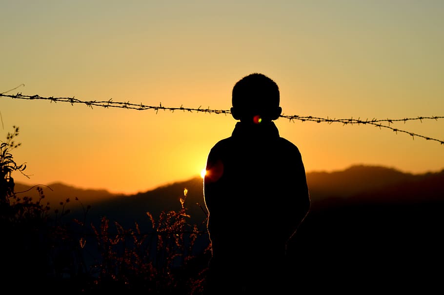 Silhouette of Boy Standing Near Barbed Wire Fence during Golden Hour, HD wallpaper