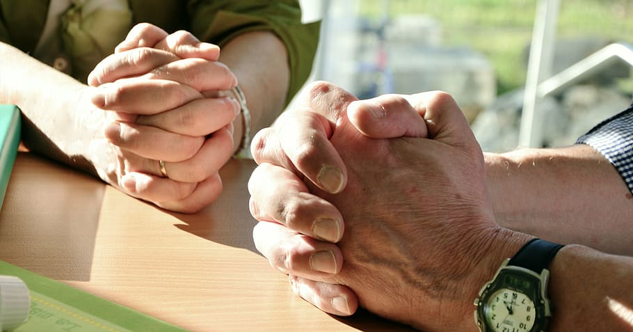 two man and woman's hand on top of table, hands, pray, prayer