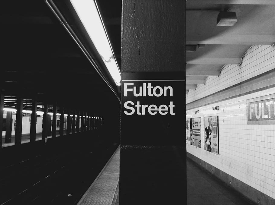 grayscale photo of Fulton Street train station sign with no people