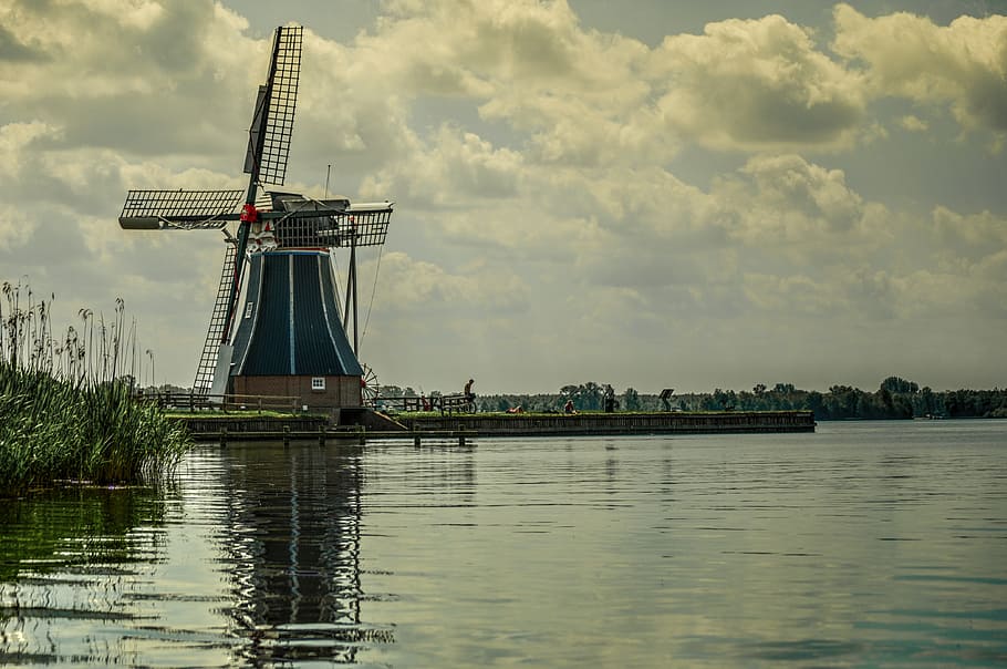 green and black windmill beside body of water under white cloudy sky at daytime, HD wallpaper