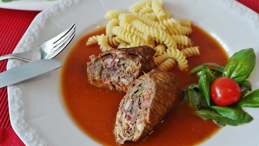 cooked pasta with sauce on white plate, roulades, beef roulades