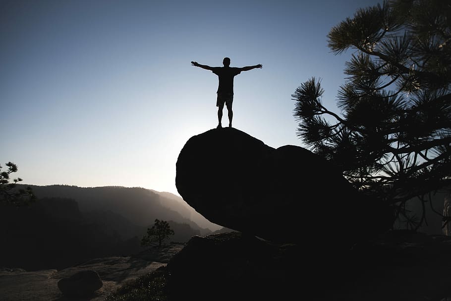 silhouette of man standing on boulder during daytime, silhouette of man standing on huge rock, HD wallpaper
