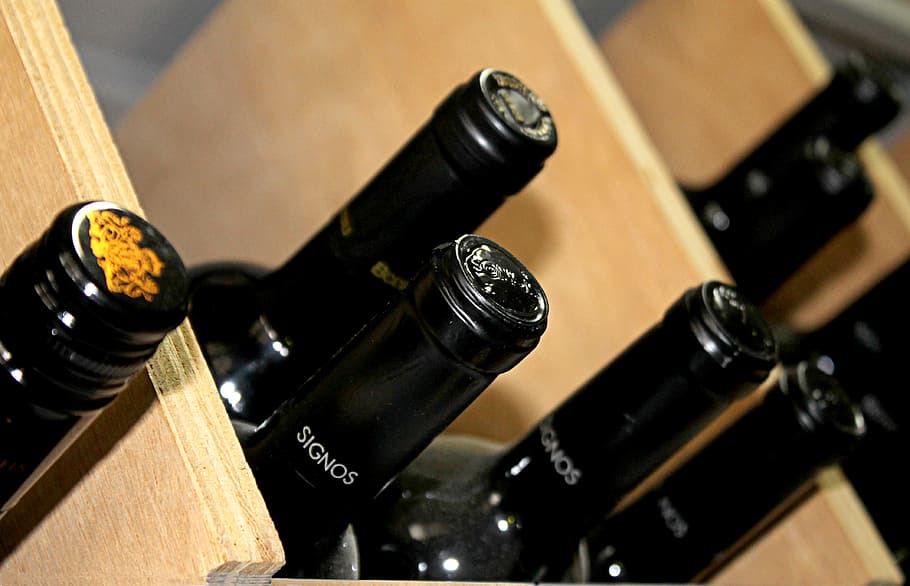 focus photo of black Signos bottles on brown wooden shelf, cellar HD wallpaper