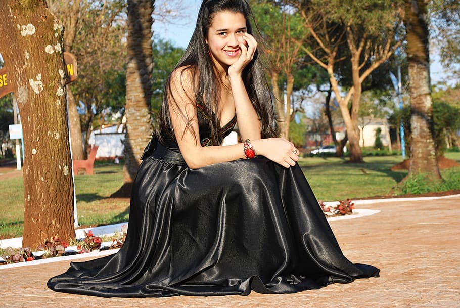 woman wearing black silk sleeveless dress, black dress, smile