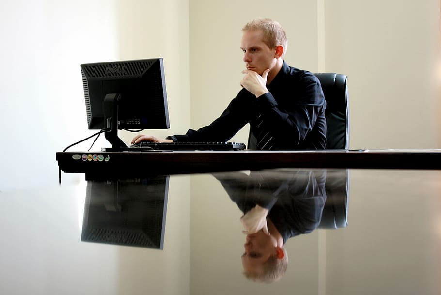 man looking at computer monitor, people, guy, office, desk, work