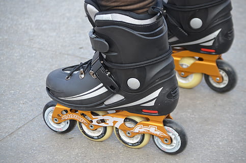 person wearing black-and-orange inline skates, Rollerblade HD wallpaper