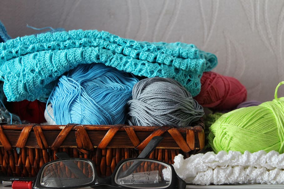 blue, green, and gray yarns on basket near black framed eyeglasses HD wallpaper