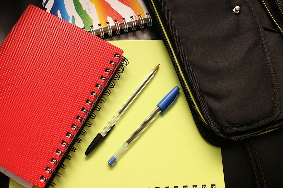 black and blue ballpoint pens on yellow notebook, school, binders HD wallpaper