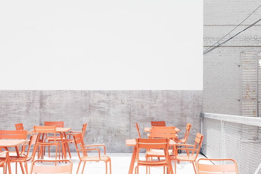 beige wooden table and chairs on rooftop during day, orange metal chairs and tables on rooftop during daytime HD wallpaper