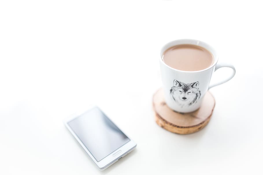 White desk with a cup of coffee and mobile phone, device, morning HD wallpaper