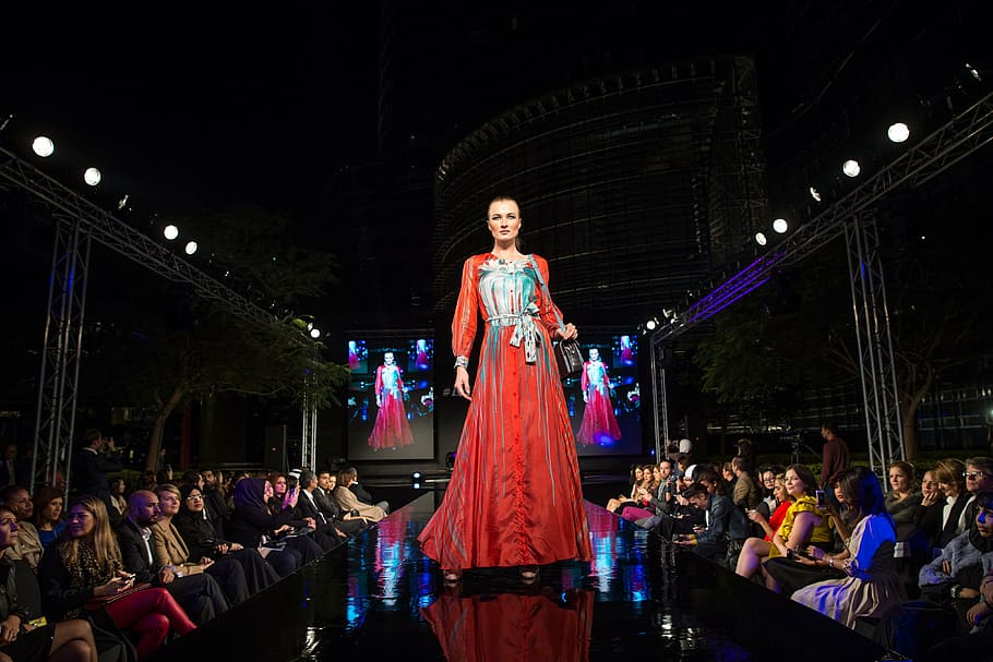 woman wearing red and blue long-sleeved dress, fashion show, catwalk