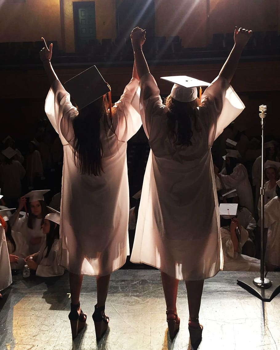 two woman in white academic dress, graduation, graduation cap