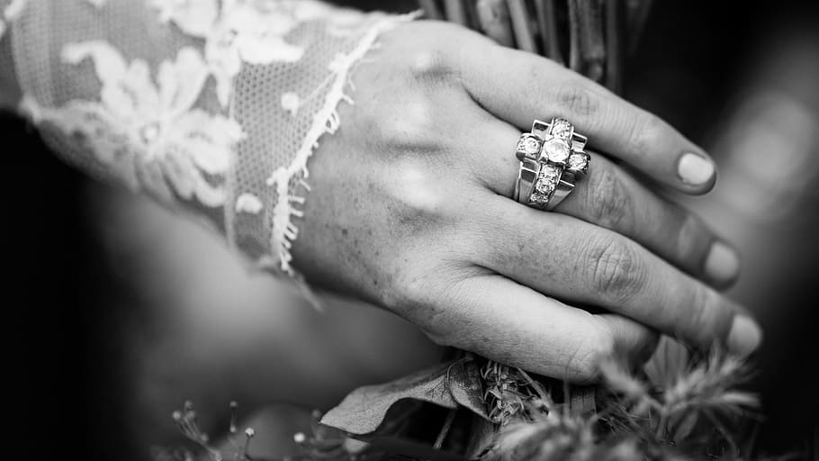 person wearing ring on finger, grayscaled photo of ring with gemstones HD wallpaper