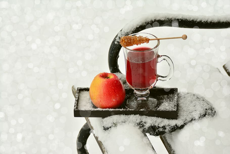 clear glass footed mug and red apple on black wooden ice covered tray HD wallpaper