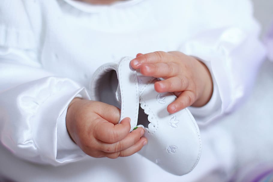 photo of baby holding white shoe, holding hands, keep, children HD wallpaper