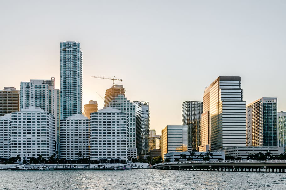 white concrete buildings near body of water at daytime, architectural photography of white buildings HD wallpaper