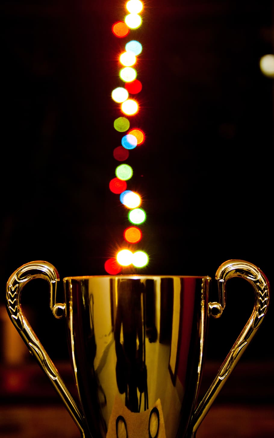 gold trophy figure with bokeh effect, award, cup, lights, prize