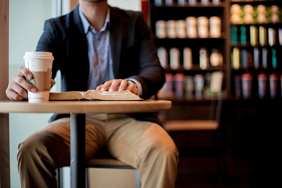 man sitting touching book and holding cup, people, chair, table HD wallpaper