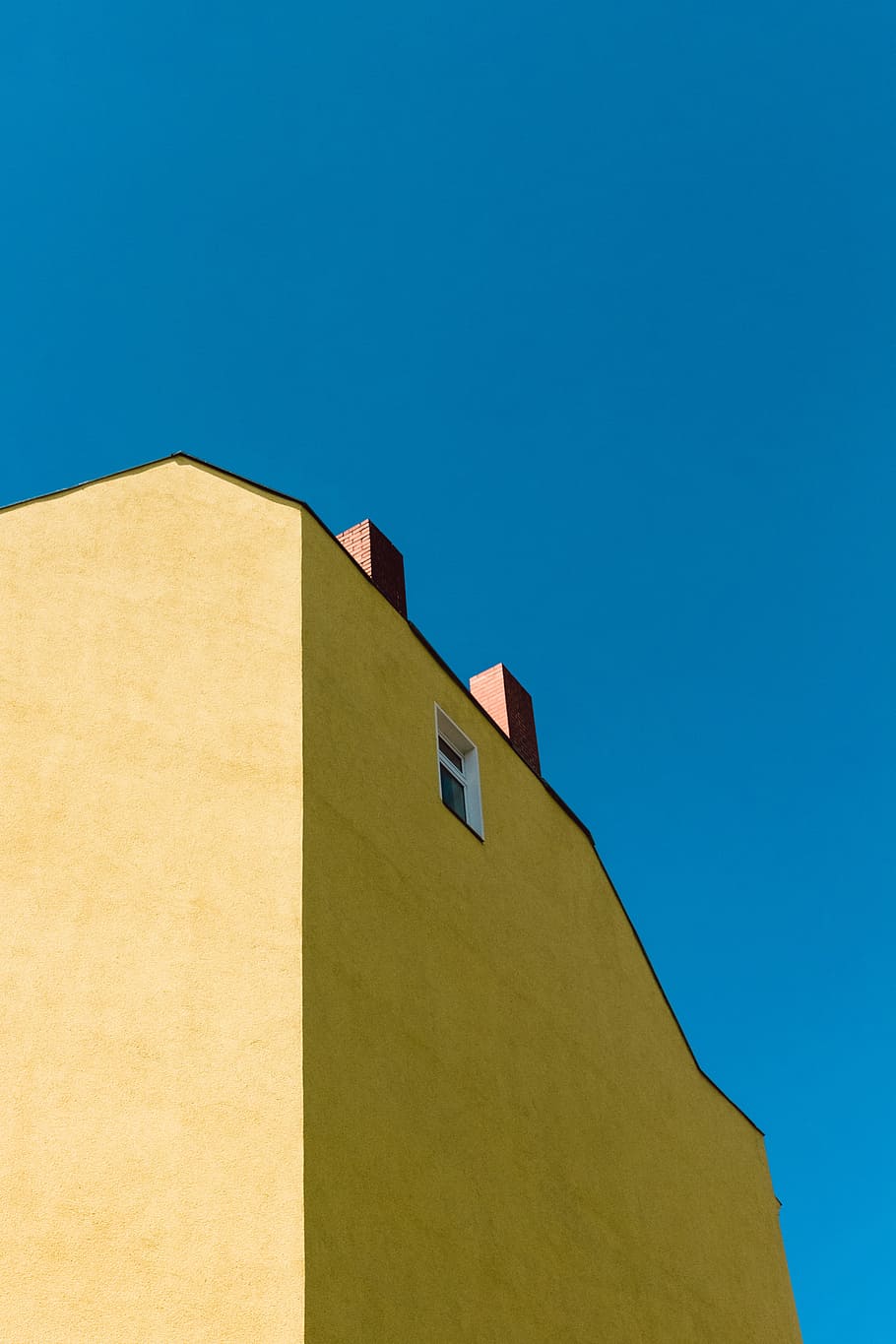low-angle photography of yellow concrete building under blue sky, brown concrete buidling HD wallpaper